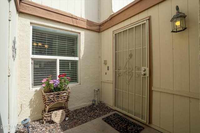 doorway to property with stucco siding