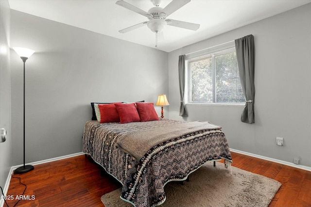 bedroom featuring baseboards, a ceiling fan, and hardwood / wood-style flooring
