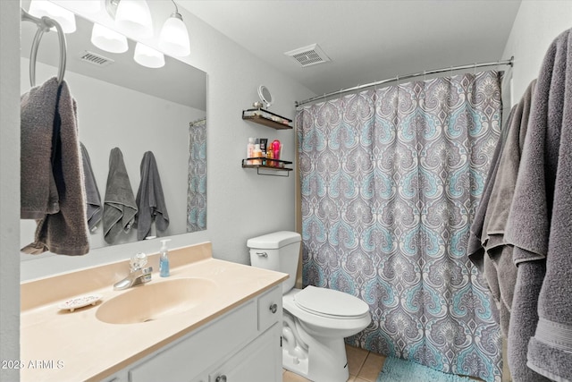 bathroom featuring toilet, vanity, tile patterned floors, and visible vents
