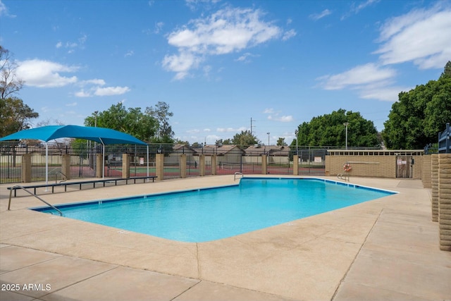 pool featuring fence and a patio