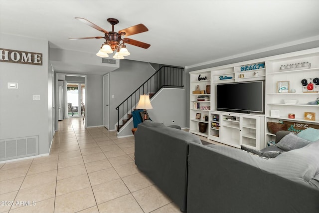living room with stairs, baseboards, light tile patterned flooring, ceiling fan, and visible vents