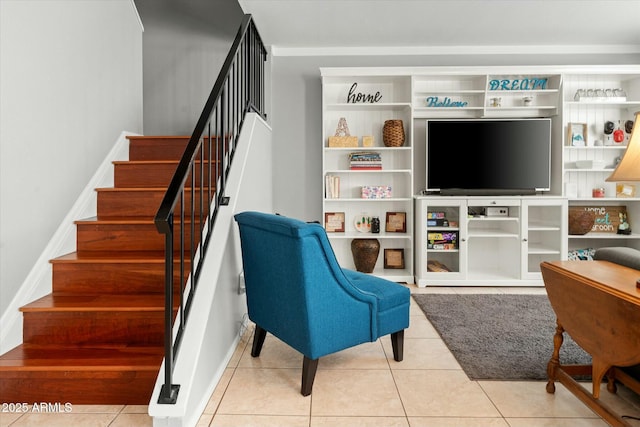 interior space featuring tile patterned flooring, baseboards, and stairway