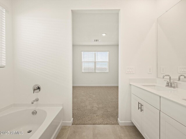 bathroom with vanity, tile patterned floors, and a bathing tub