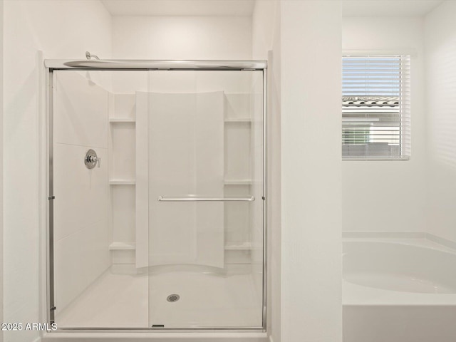 bathroom featuring independent shower and bath