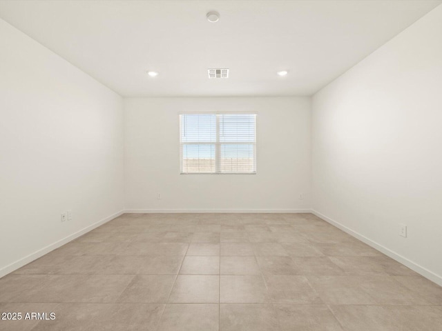 unfurnished room with light tile patterned flooring