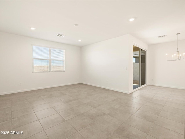 tiled empty room featuring a notable chandelier