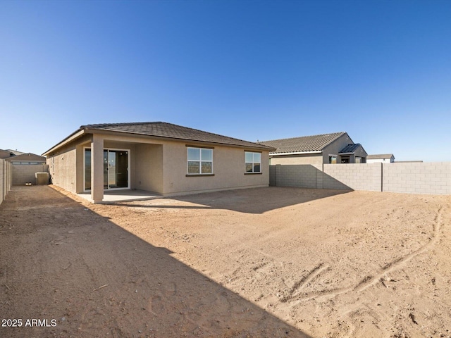 back of property with a patio