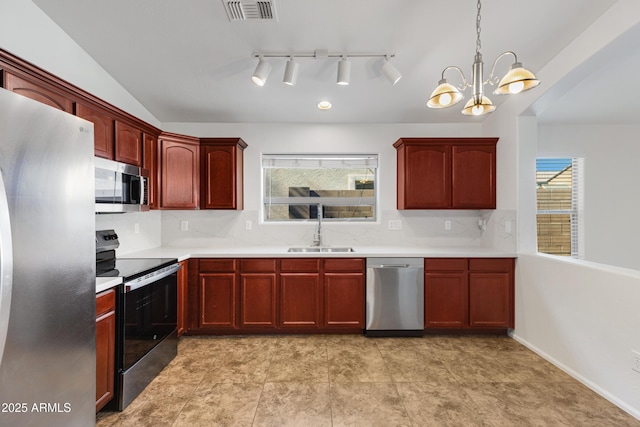 kitchen featuring sink, hanging light fixtures, a healthy amount of sunlight, and appliances with stainless steel finishes