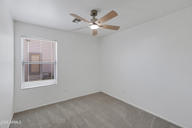 empty room featuring ceiling fan and carpet floors