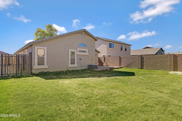 rear view of property featuring a yard