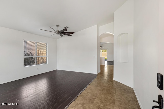 empty room with dark hardwood / wood-style flooring and ceiling fan