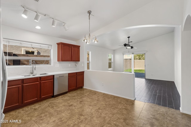 kitchen featuring ceiling fan with notable chandelier, lofted ceiling, sink, hanging light fixtures, and stainless steel dishwasher