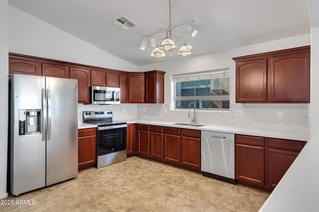 kitchen with vaulted ceiling, decorative light fixtures, sink, a notable chandelier, and stainless steel appliances