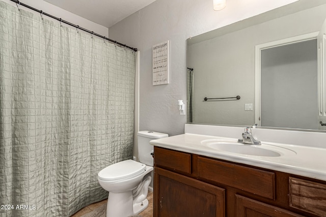 bathroom with vanity, toilet, and a shower with shower curtain