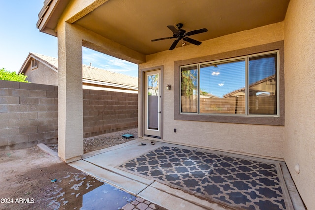 doorway to property featuring ceiling fan and a patio area