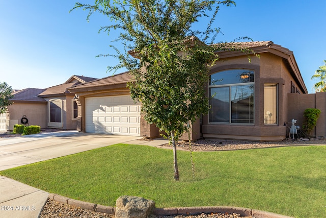 view of front of home featuring a front yard and a garage