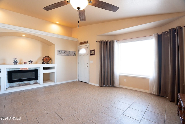 unfurnished living room featuring ceiling fan and light tile patterned floors