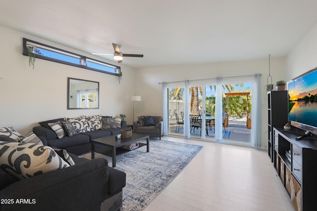 living room featuring wood finished floors and ceiling fan