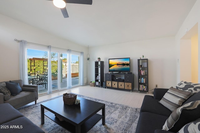 living room with wood finished floors and a ceiling fan