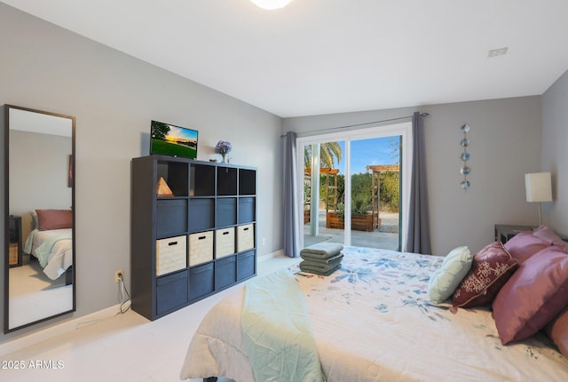 carpeted bedroom featuring access to exterior and baseboards