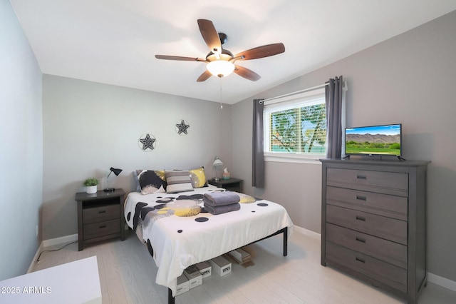 bedroom with baseboards, light wood finished floors, and ceiling fan