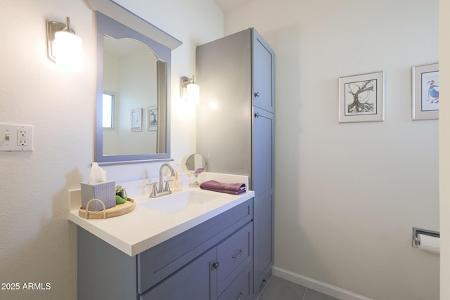 bathroom featuring baseboards, vanity, and tile patterned flooring