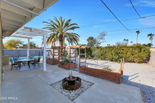 view of patio with outdoor dining space, a garden, a fenced backyard, and a pergola