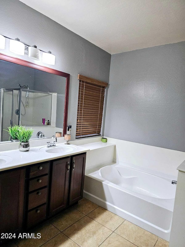 bathroom featuring tile patterned floors, plus walk in shower, and vanity