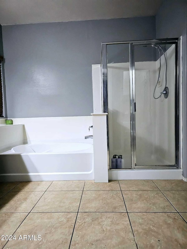 bathroom featuring a tub to relax in and tile patterned floors