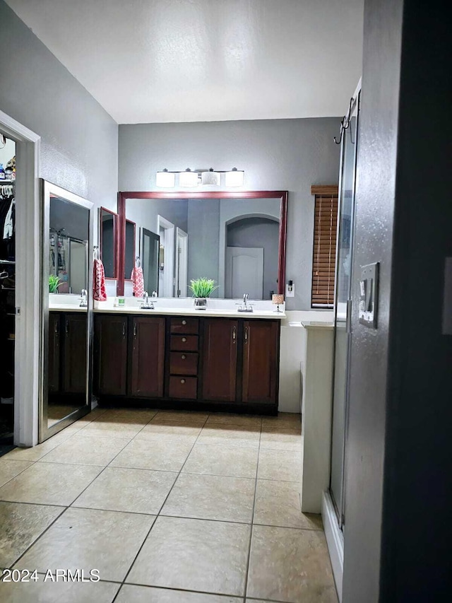 bathroom featuring tile patterned floors, vanity, and walk in shower