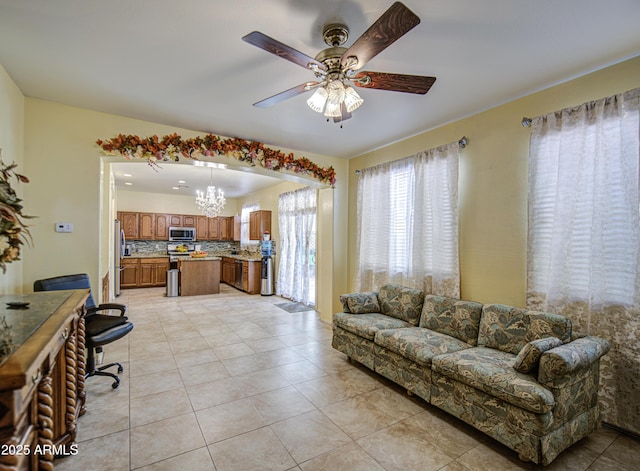 17374 W Adams St, Goodyear, AZ 85338 - living area featuring light tile patterned flooring and ceiling fan with notable chandelier