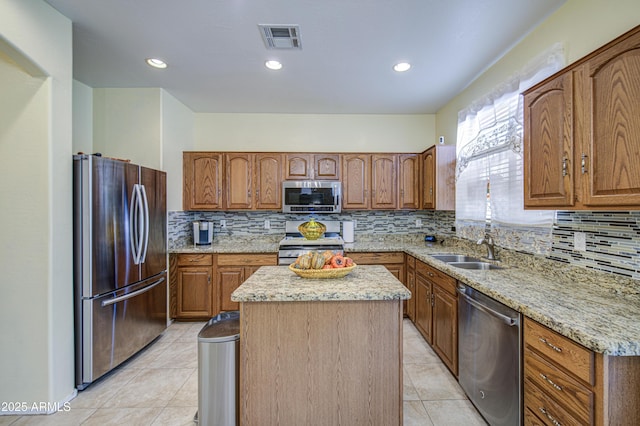 17374 W Adams St, Goodyear, AZ 85338 - kitchen with visible vents, backsplash, light tile patterned floors, a kitchen island, and appliances with stainless steel finishes