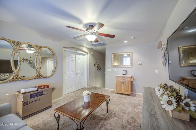 17374 W Adams St, Goodyear, AZ 85338 - living area with light colored carpet, visible vents, baseboards, and a ceiling fan