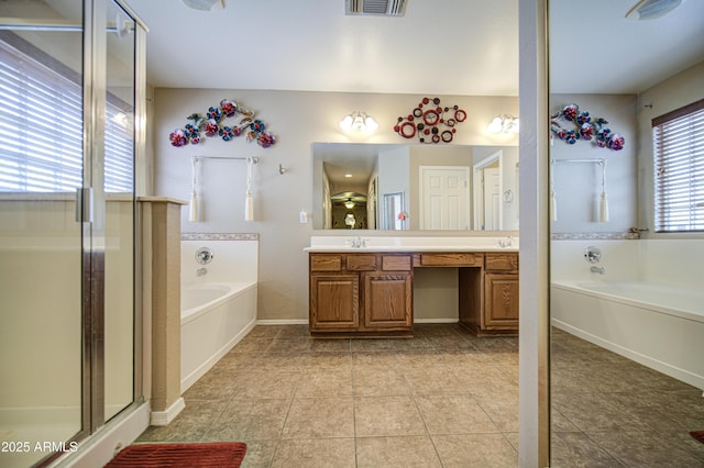 17374 W Adams St, Goodyear, AZ 85338 - full bathroom featuring double vanity, a garden tub, tile patterned floors, and a sink