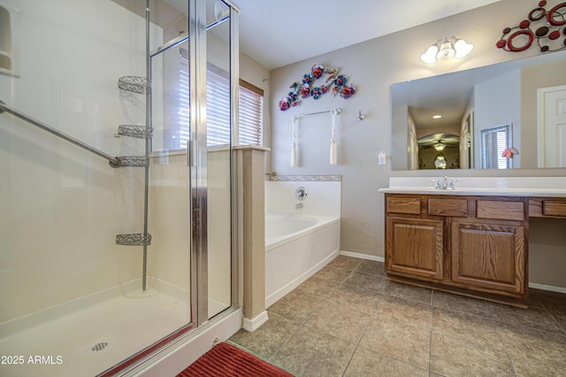 17374 W Adams St, Goodyear, AZ 85338 - bathroom featuring vanity, baseboards, a shower stall, and a bath