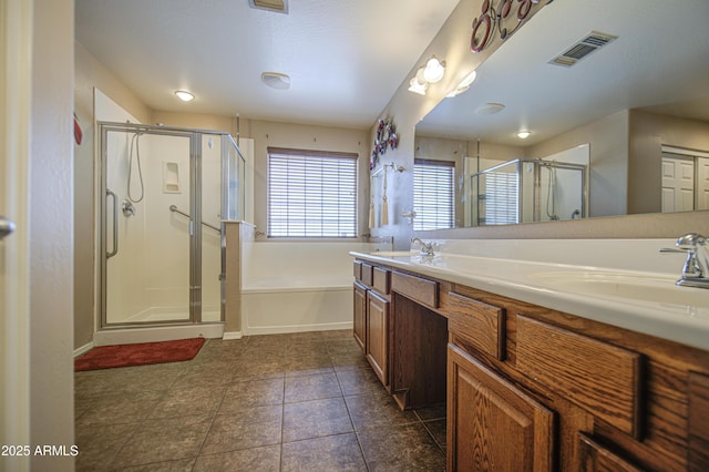 17374 W Adams St, Goodyear, AZ 85338 - full bath with a stall shower, visible vents, a sink, a garden tub, and double vanity