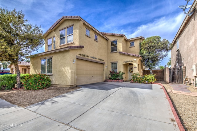 17374 W Adams St, Goodyear, AZ 85338 - mediterranean / spanish-style home with a garage, a tiled roof, stucco siding, fence, and concrete driveway