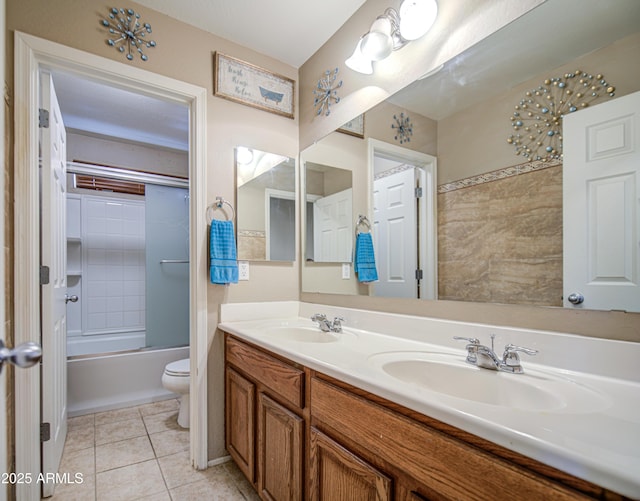 17374 W Adams St, Goodyear, AZ 85338 - full bathroom featuring toilet, tile patterned floors, double vanity, and a sink