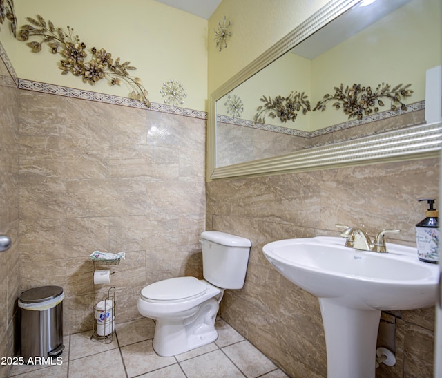 17374 W Adams St, Goodyear, AZ 85338 - half bath featuring tile walls, toilet, tile patterned flooring, and a wainscoted wall