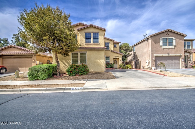 17374 W Adams St, Goodyear, AZ 85338 - view of front facade with concrete driveway, a tiled roof, and stucco siding
