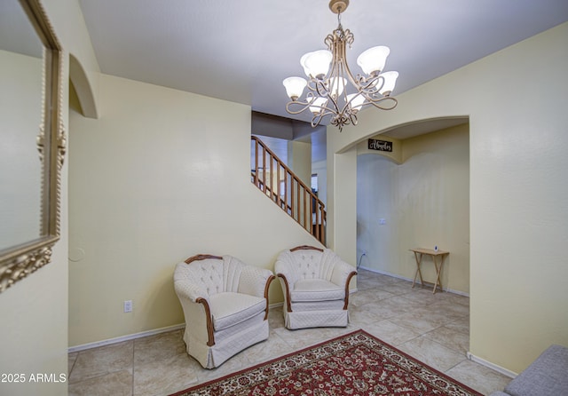 17374 W Adams St, Goodyear, AZ 85338 - living area featuring a chandelier, baseboards, arched walkways, and stairway