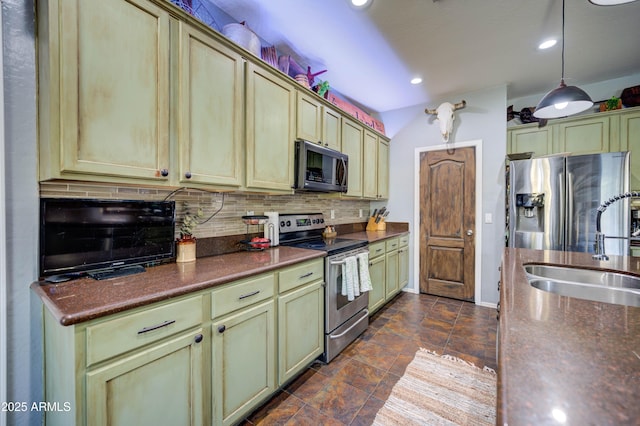 kitchen featuring pendant lighting, sink, green cabinets, appliances with stainless steel finishes, and tasteful backsplash