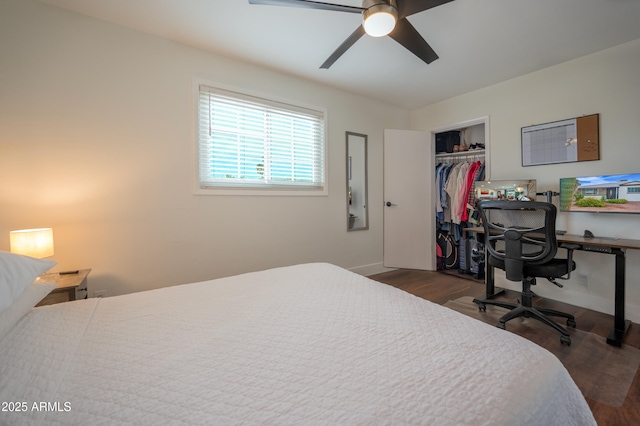 bedroom with ceiling fan, a closet, and dark wood-type flooring