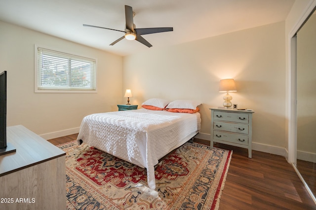 bedroom featuring ceiling fan, a closet, and dark wood-type flooring