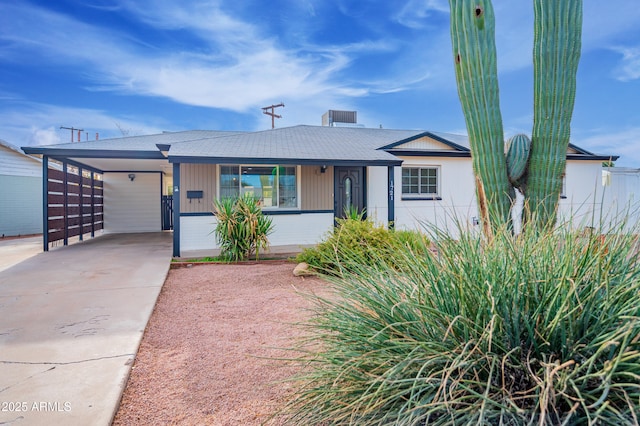 ranch-style home with a carport and covered porch