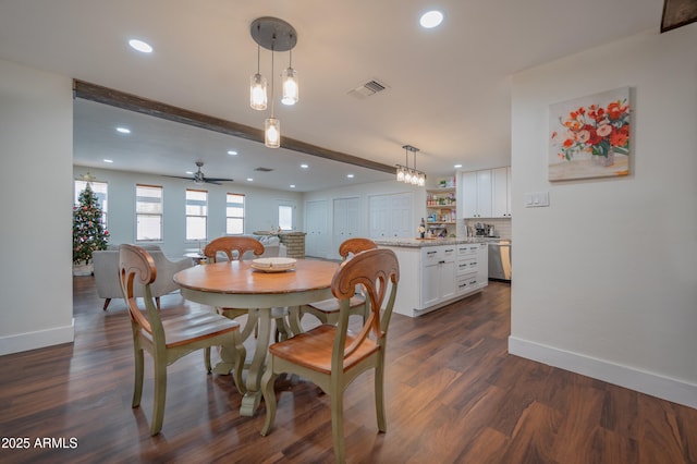 dining area with beamed ceiling, dark hardwood / wood-style flooring, and ceiling fan