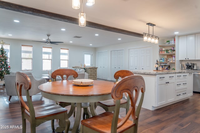 dining room with beam ceiling, ceiling fan, and dark wood-type flooring