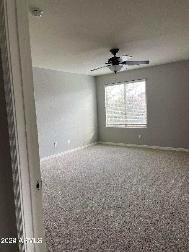 carpeted empty room with ceiling fan