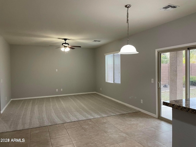 empty room featuring ceiling fan and light tile patterned floors