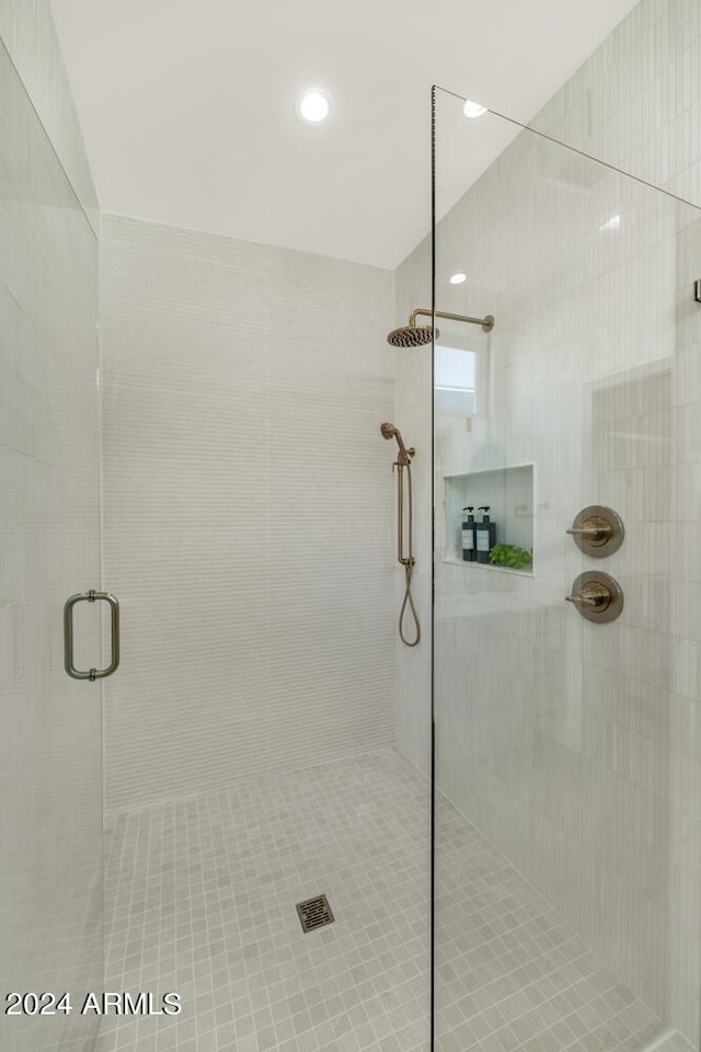 bathroom featuring a shower with door